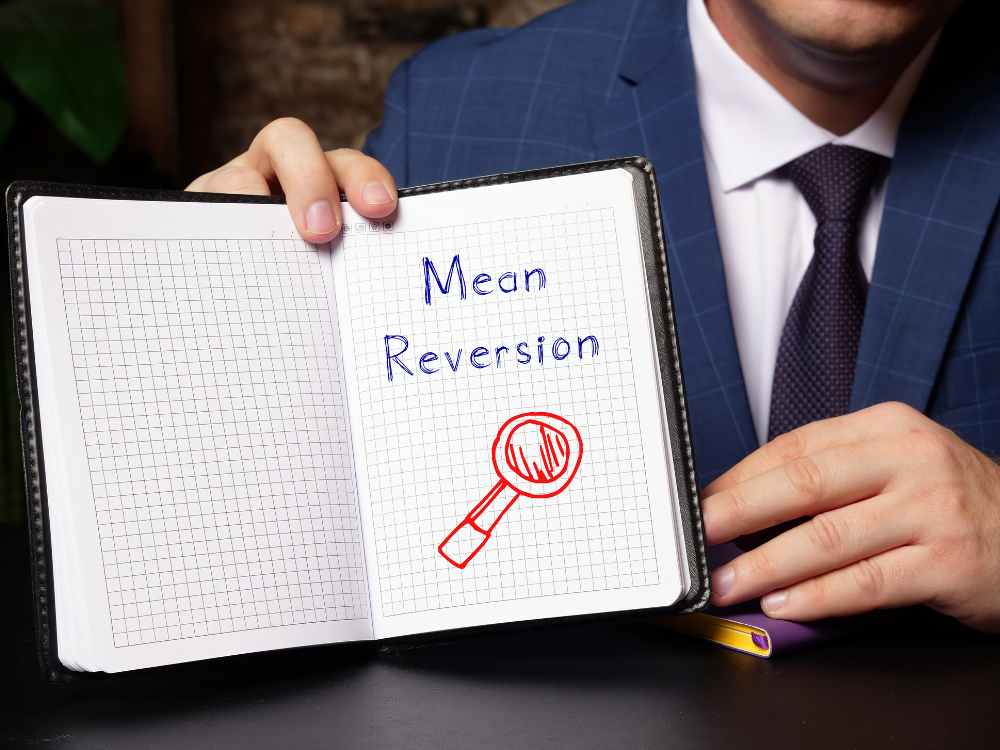 Man holding a sign that says mean reversion