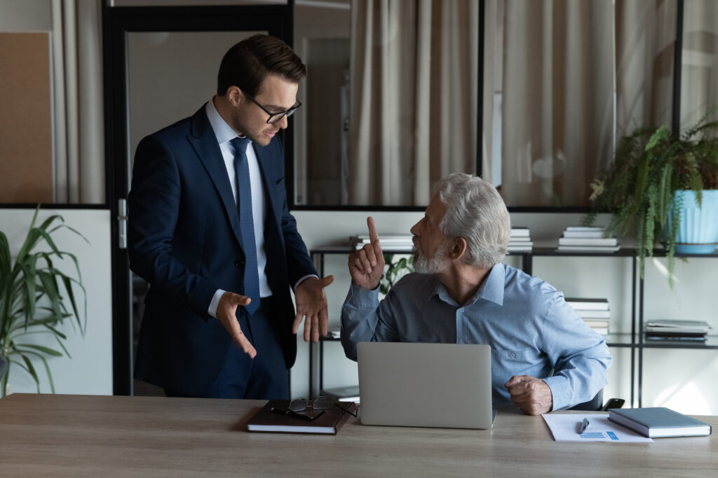 Photo of a young executive arguing with an older man, representing the view that investors need to ask tough questions about private market funds