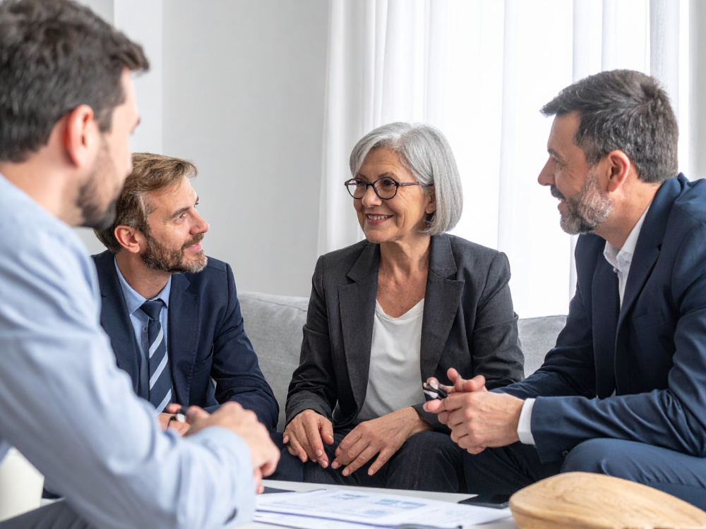 People in an office meeting around a coffeetable.