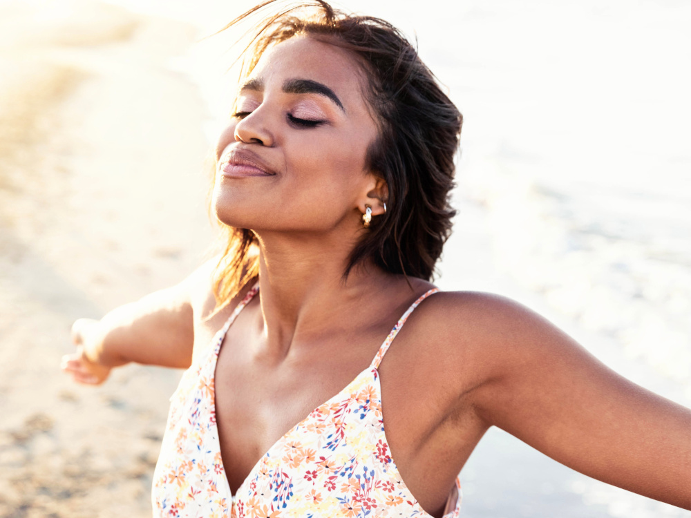 Image of a woman on a beach relaxing.