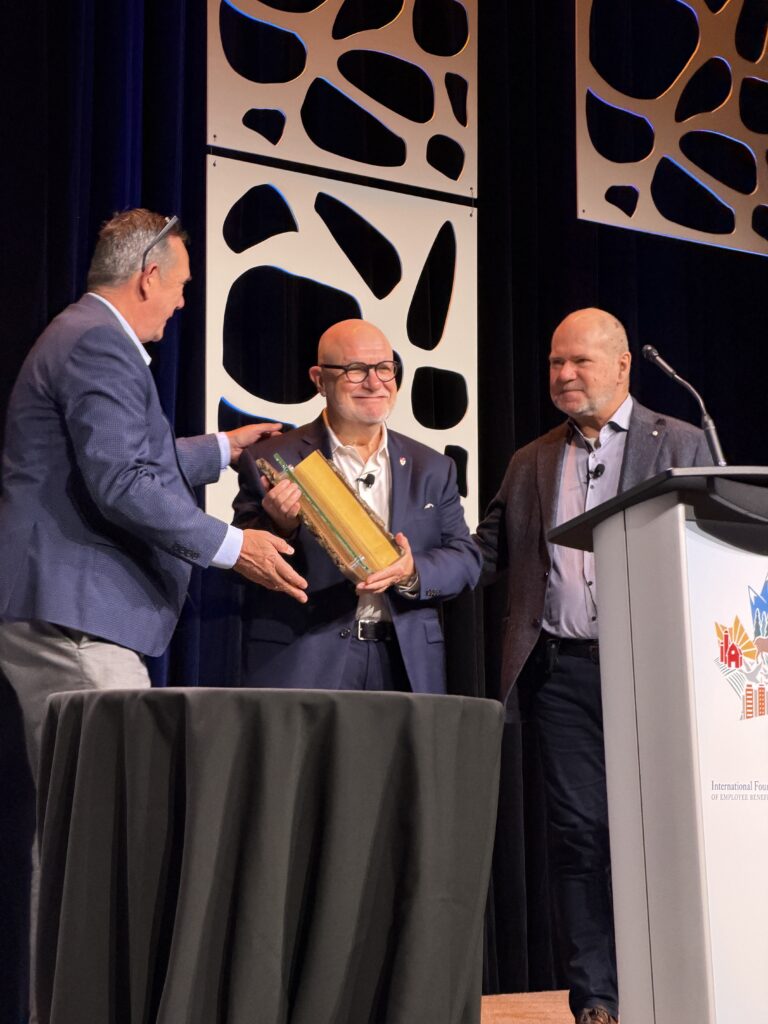 Photo of Sam Reda as he accepts Sam Reda accepts the Canadian Lifetime Volunteer Award from the IBEFP in November 2025