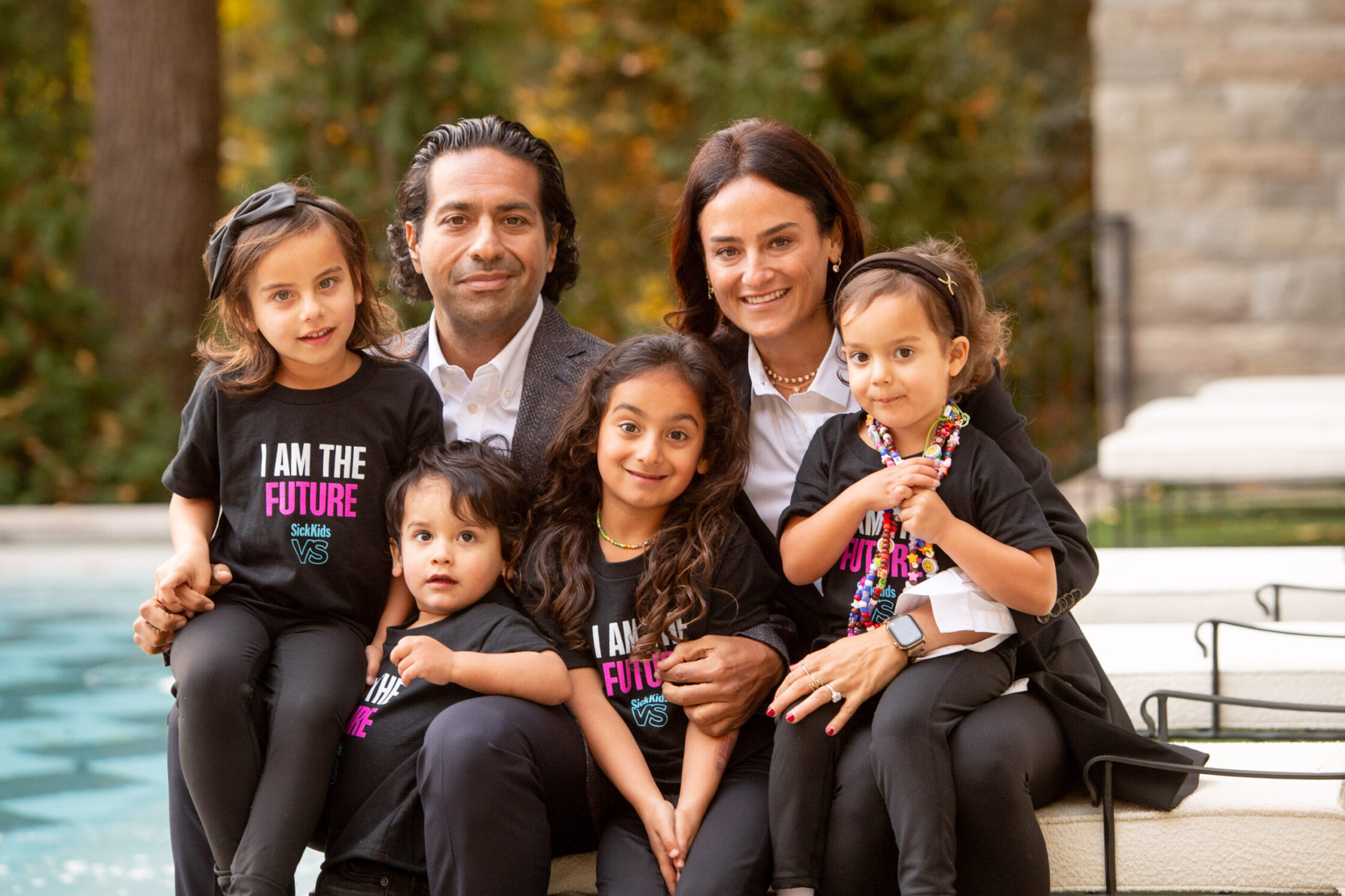 Photo of Moez and Marissa Kassam, with their children. The Kassams are major philanthropic supporters of healthcare causes in Canada.