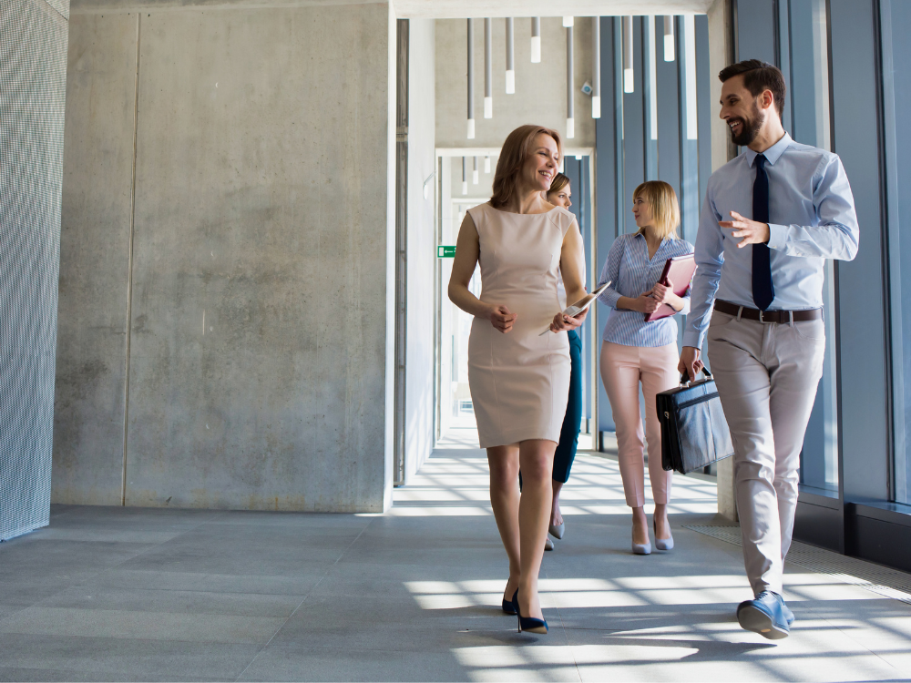 person walking down a hallway discussing a family office
