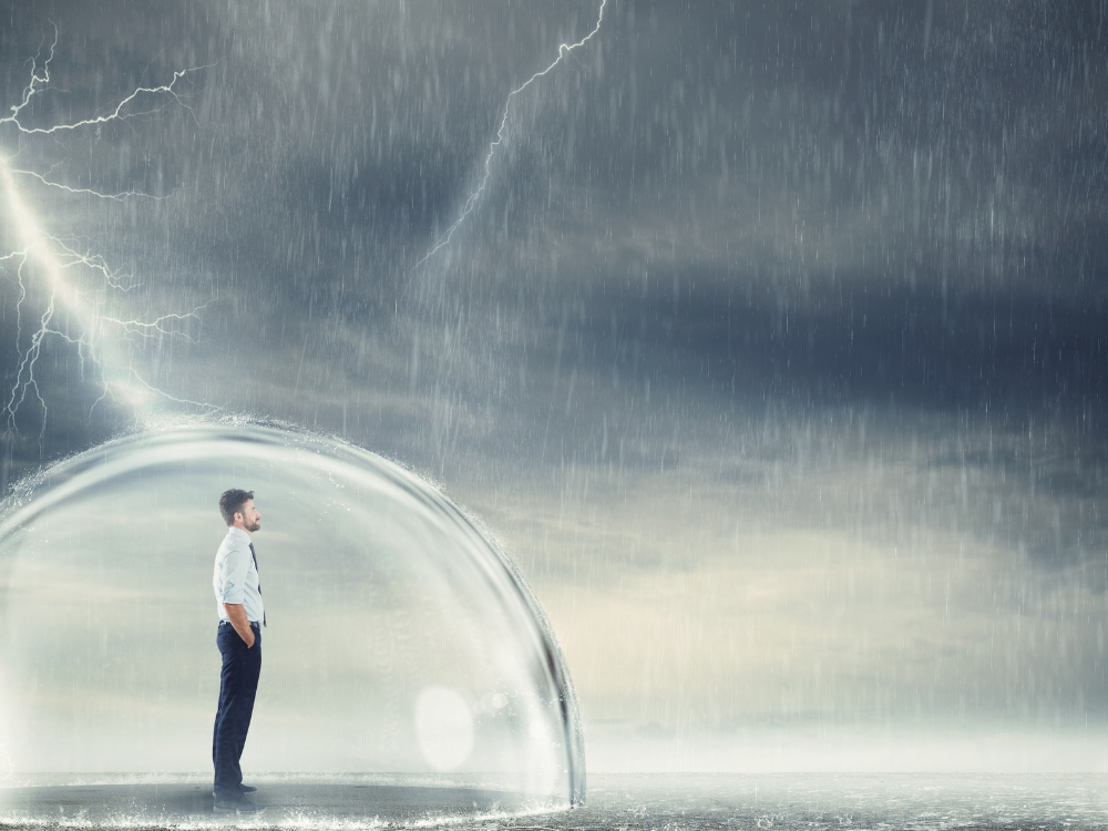 Man standing in a bubble trying to protect himself