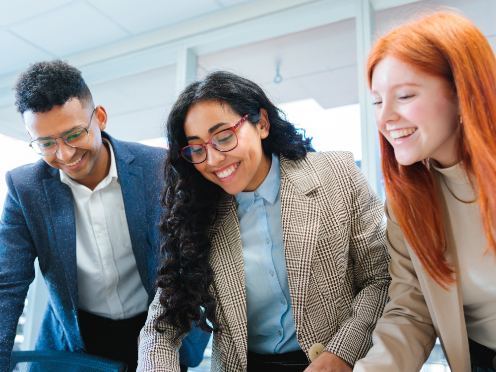Gen Z looking at a computer together in an office