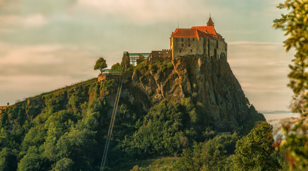 A photo of one of four towns to know in Vulkanland, Riegersburg is perched on a sheer cliff of basalt—the rock that gives many Vulkanland wines their distinctive character